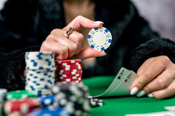 girl in the poker game has won everything and takes all the chips with her hands.