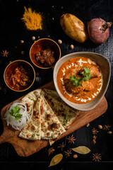 Chicken tikka masala spicy curry meat food Butter chicken with rice and naan bread on dark background close-up