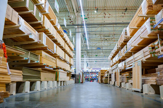 racks with wooden boards and slabs in the warehouse of the hardware store. 