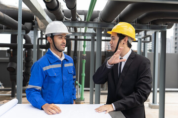 At construction site manager visit engineer working on the rooftop near pipe rack to inspection the...