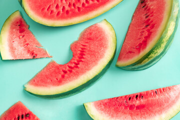 Fresh juicy red watermelon, watermelon slice over blue background, Design for wallpaper, greeting season card. Summer vitamins, berries