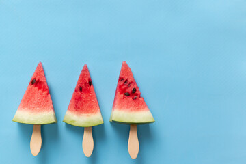 Fruit ice cream. Summer watermelon slice popsicles on blue background. Design for cover, wallpaper, device screen