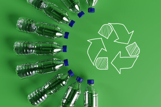 Plastic bottles with the recycling icon and painted recycling arrows. Concept of nature and environment protection. Plastic recycling. 3d render