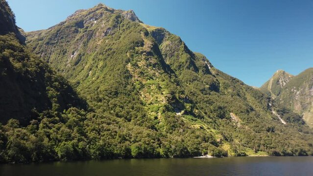 Stunning scenic view of Doubtful Sound surroundings of untouched tropical nature in New Zealand fjord.