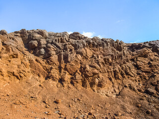 Orange-brown desert stone rock in the Sinai desert near Sharm El Sheikh, Egypt. Natural geological background with copy space