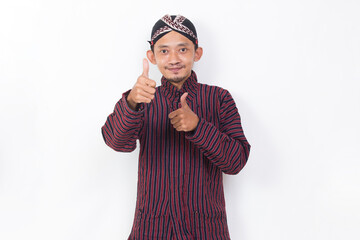 asian man with javanese traditional cloth lurik with ok sign gesture tumb up isolated on white background
