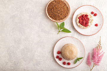 Buckwheat milk jelly on gray concrete, top view, copy space.