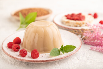 Buckwheat milk jelly on gray concrete, side view, selective focus.