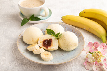 Japanese rice sweet buns mochi filled with jam on a gray concrete. side view.