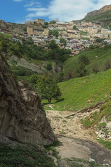 Fototapeta na wymiar Alpine village Chokh, Republic of Dagestan. North Caucasus. Daytime landscape among the mountains. An ancient village rich in history. View of the stepped building.