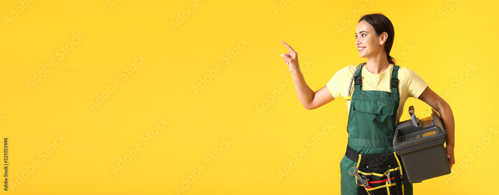 Poster female worker with tools bag pointing at something on yellow background with space for text