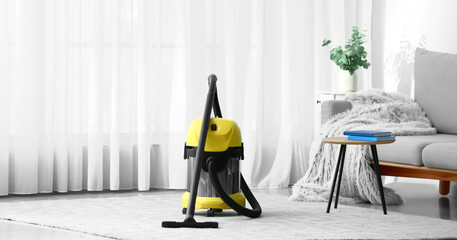 Modern vacuum cleaner in room