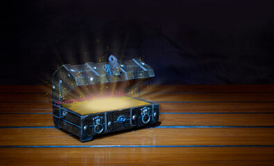 Secret wooden box of success concept with shiny light on black banner