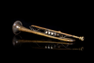 Golden color vintage trumpet on black reflection - music concept
