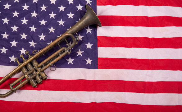 Honoring US Army Veterans with trumpet on United States Flag