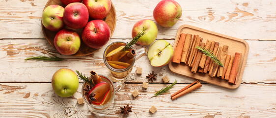 Composition with tasty mulled wine and ingredients on light wooden background, top view