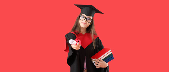 Female graduating student with diploma and books on red background