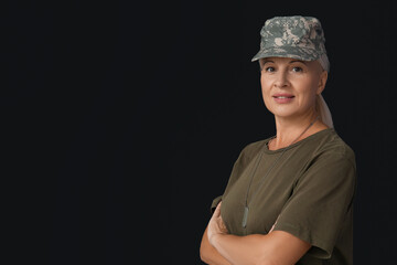 Mature female soldier on black background