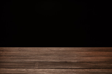 Wooden table top on black background