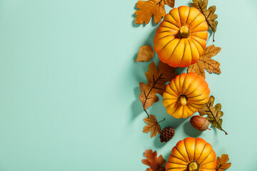 Autumn background creative layout with decorative small pumpkins and autumn leaves