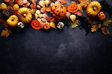 Fotobehang Pumpkins with Halloween decorations on dark background © Natalia Klenova