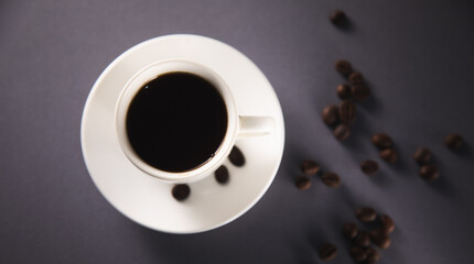 Coffee beans roasted in a white coffee cup