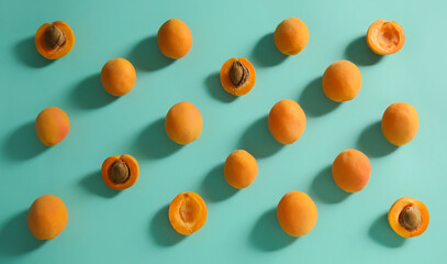 Composition with ripe apricots on color background