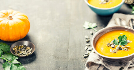 Pumpkin soup in a bowl son a wooden surface