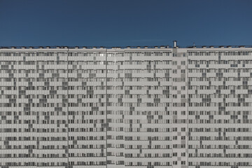 Facade of a nondescript residential monotonous multi-storey building.