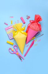 School cones with stationery on blue background