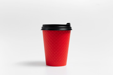 Close-up of red paper cup of coffee takeaway on white background.