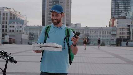 Delivery man doing fast food delivery service with electric scooter taking order via app in smart phone