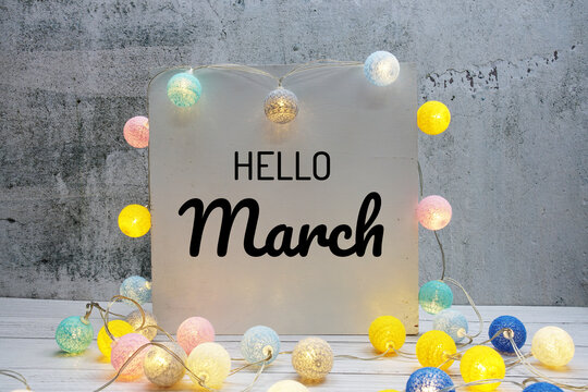 Hello March Text Message With LED Cotton Ball Decoration On Wooden Background