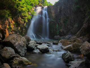 Waterfall. Image of magnificent waterfall flowing from the depths of the forest. Sudusen waterfall....
