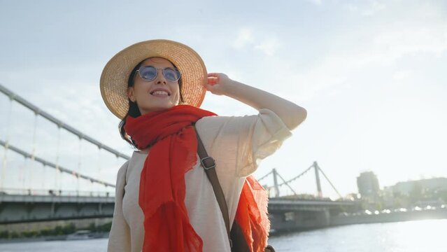 Young girl in a hat in a sunny city on vacation
