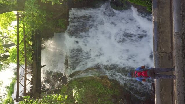 man taking a selfie at the waterfall