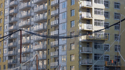 Fototapeta na wymiar Electrical cable and new high-rise skyscraper building. New high construction.