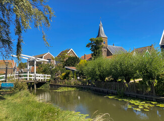 Sunny summer day in small Dutch town Marken with wooden houses located on former island in North...