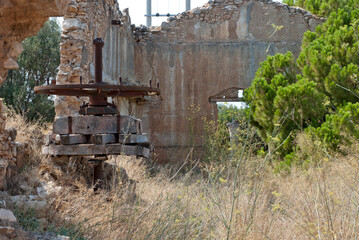 Obraz na płótnie Canvas Athens, Greece / July 2022: Wine making facility ruins dating to 1875. Old wine press