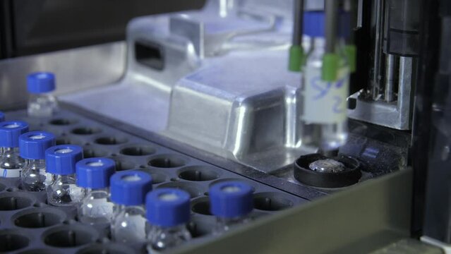 Agilent G1329B Autosampler variable volume, takes samples and mixes them together with dramatic lighting  - HPLC - cloes up shot