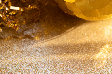 Abstract festive background with shine and glowing gold particles and circles on beige sparkling...