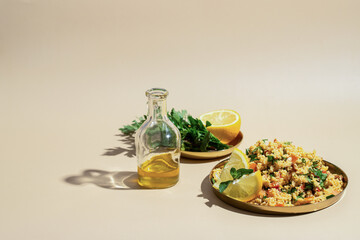 Healthy vegetarian salad with  chopped parsley, tomatoes, mint, onion, bulgur and seasoned with olive oil  on beige background with shadow