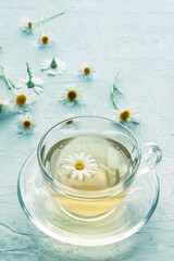 Chamomile tea in a cup with loose flowers, herbal medicine treatment, with loose flowers