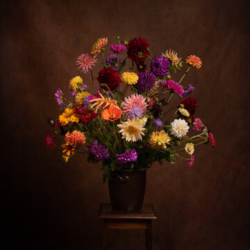 renaissance still life with vase and bouquet of classic zinnia and dahlia flowers
