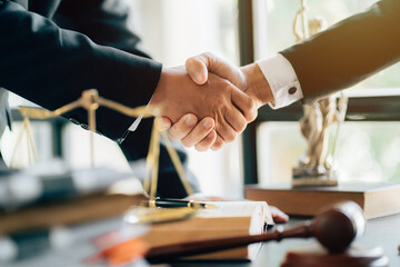 Businessman shaking hands to seal a deal with his partner lawyers or attorneys discussing a contract agreement.Legal law, advice, and justice concept