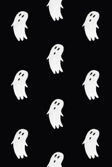 Horror pattern made of ghosts on black background. Minimal spooky idea. Halloween or Santa Muerte concept.