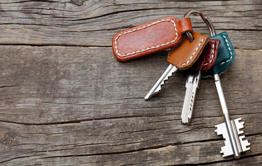 Keys with an empty keyring. Keys and leather keychain on old wooden boards. Copy space for text. mockup