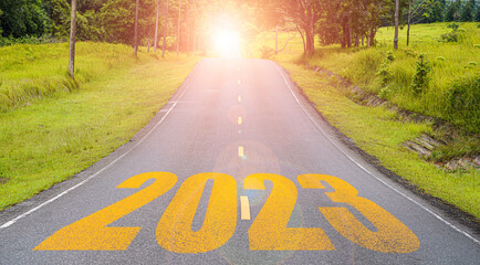 Yellow 2023 on long asphalt road for up coming of merry Christmas and happy new year concept.