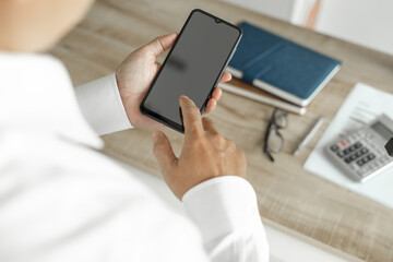 Business man using telephone to communicate business investment, man in white shirt standing in office