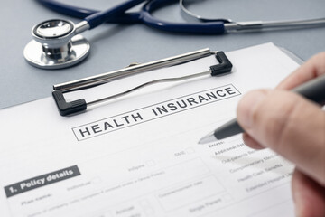 Health Insurance form and stethoscope on desk